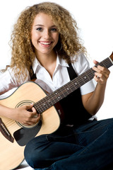 A pretty young woman playing acoustic guitar on white background