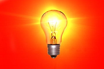 Electric lamp luminous yellow light on a red background