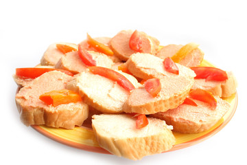 On a photo a sandwiches with caviar and a tomato. It is isolated