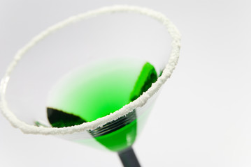 Green cocktail with salted rim in Art Deco glass