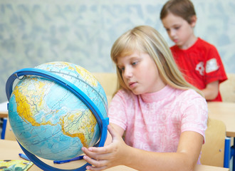 The schoolgirl considers the globe
