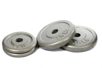 Obraz premium A small pile of weight plates, over white.