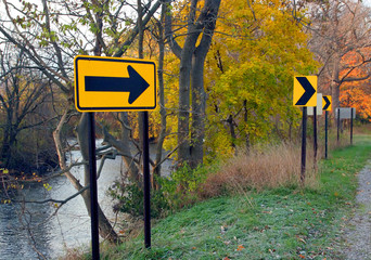 road signs at river edge