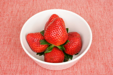 strawberries on a pink placemate
