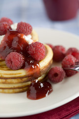 Delicious pancakes with raspberries and jelly