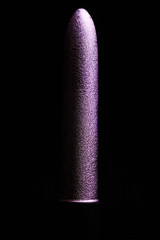 purple metallic vibrator on the black background
