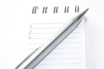 Pen on small diary. One two three