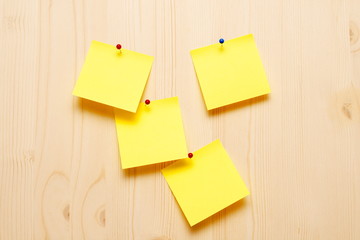 yellow sticky notes on wooden background