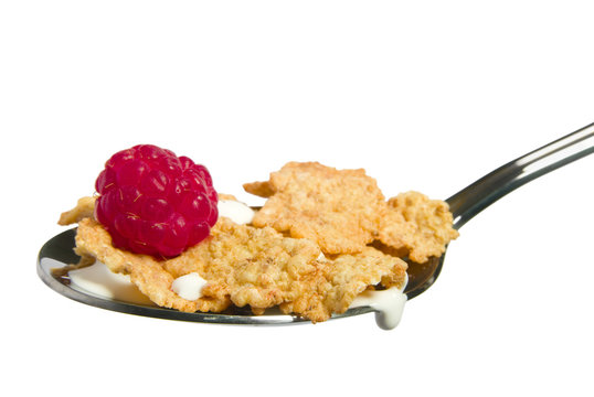 Ripe raspberry with cereal flakes isolated