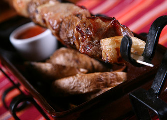 Fried kebab meat with red sauce and potato