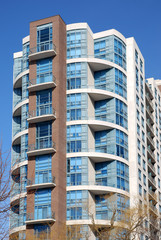apartment building with curved balcony and tinted windows