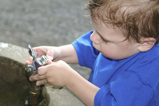 Toddler and water fountain