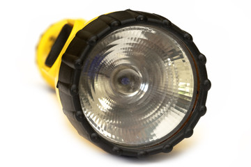 Yellow and black flashlight with white background