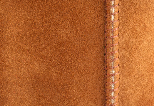 Brown suede background with seam