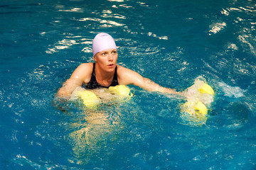Girl in water with dumbbels