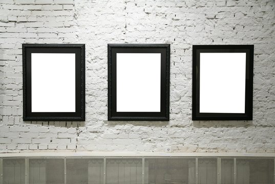 black frames on white brick wall
