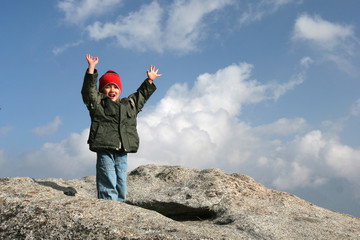 Young kid on top of the mountain