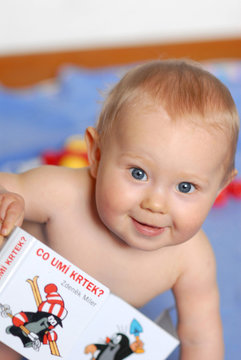A baby with a book