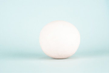 White radish isolated on light blue background. Studio vegetable photography. Raw food and minimal healthy eating concept. Design for banner, poster, wallpaper, print. Front view with copy space