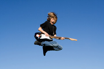 happy child playing guitar or musical instrument - 6525119