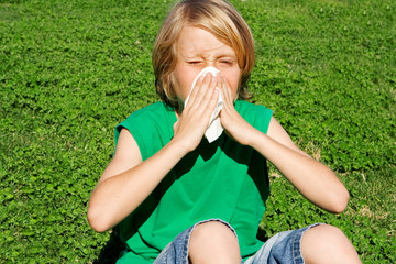 child with allergy or hay fever sneezing