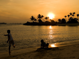 Boys Playing on the Beach at Sunset