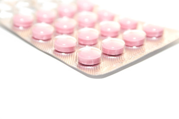 pink tablets on the white isolated background