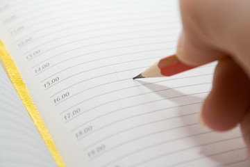 red pencil in hand over blank notes