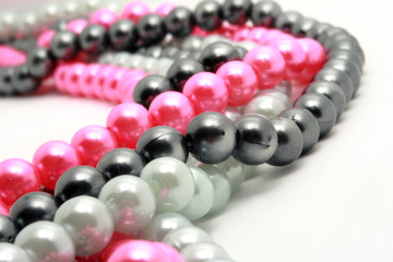 Multicolored beads laying on white background