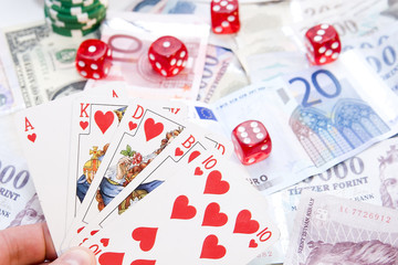 Fototapeta na wymiar Poker hands - cards have focus with poker chips and money