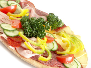 Cold food - salami and fresh vegetables served on plate