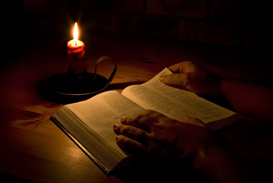 Reading The Bible By Candle Light