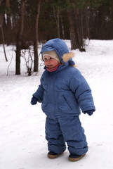 Fototapeta na wymiar Smiling child in winter overalls 