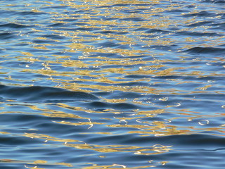 Blue water surface with sun highlights