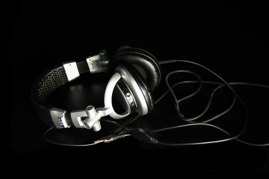 Earphones on black background witj cable