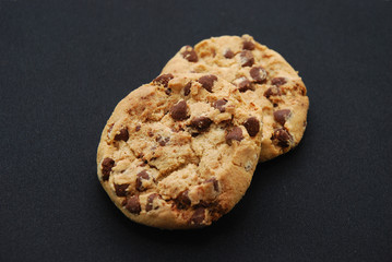 two biscuits on black background