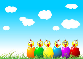 Easter chicks and eggs on grass over cloudy blue sky