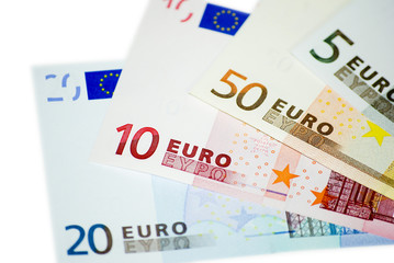 Mixed euro banknotes in denominations of 5, 10, 20, and 50 arranged in overlapping layout. Studio macro photography. Money, banking and finance concept. Design for banner, poster, wallpaper, print