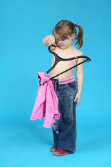 child keeps clothes hanger, blue background