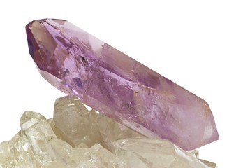 Amethyst crytal isololated on white laid on quartz