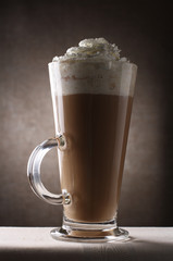 Coffee Latte in Tall Glass on brown rustic background
