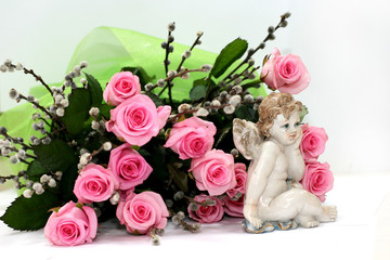 My little angel near pink roses