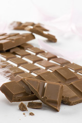 Milk chocolate close-up with decorative feathers