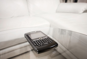 Blackberry PDA on glass table
