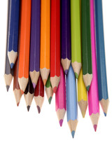 Colored pencils over white background