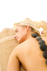 Obraz na płótnie Canvas Massage with hot volcanic stones