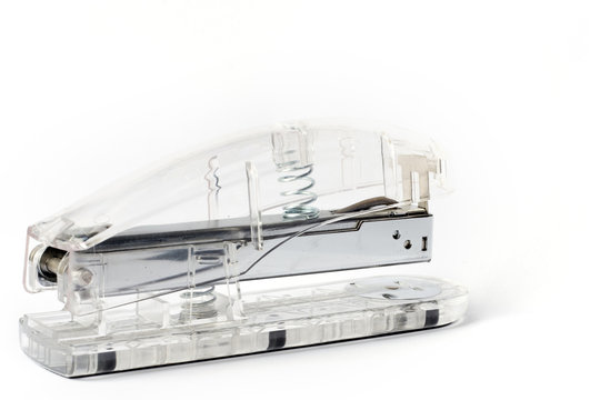 Transparent stapler on white background
