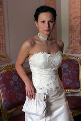Smiling bride in white corset looking sexy