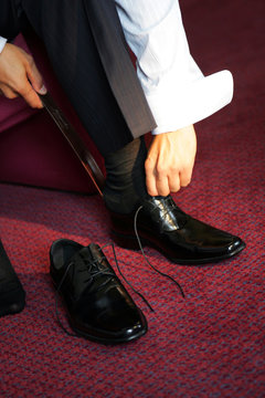 Businessman Putting On Smart Shoes For Work