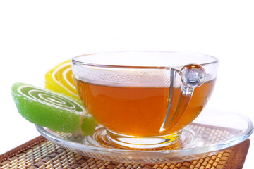 Multi-coloured  fruit candy and cup of tea